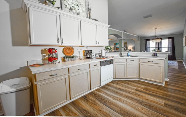 2604 Clareside Dr, Valrico, FL 33596 - kitchen featuring a sink, white dishwasher, a peninsula, and wood finished floors
