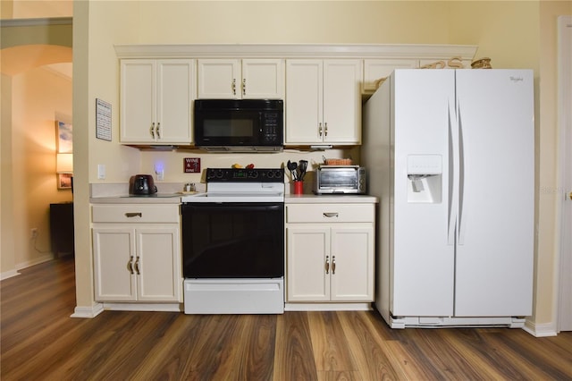 2604 Clareside Dr, Valrico, FL 33596 - kitchen featuring black microwave, white refrigerator with ice dispenser, range with electric cooktop, dark wood finished floors, and arched walkways