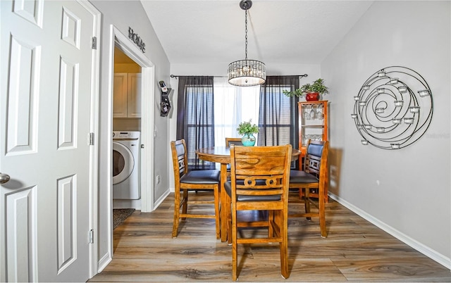 2604 Clareside Dr, Valrico, FL 33596 - dining room with washer / clothes dryer, a chandelier, wood finished floors, and baseboards
