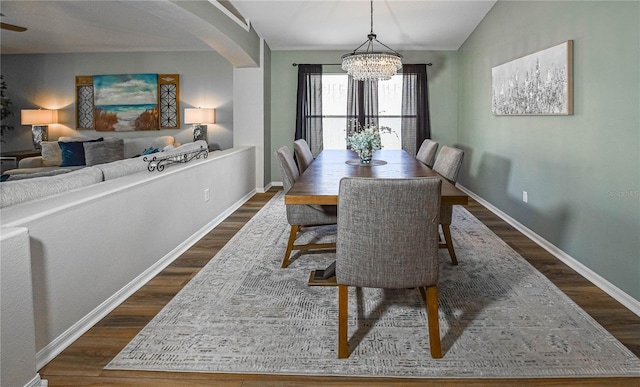 2604 Clareside Dr, Valrico, FL 33596 - dining room with dark wood-style flooring, a chandelier, arched walkways, baseboards, and vaulted ceiling