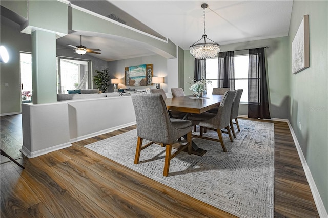 2604 Clareside Dr, Valrico, FL 33596 - dining space with a chandelier, lofted ceiling, arched walkways, dark wood finished floors, and baseboards