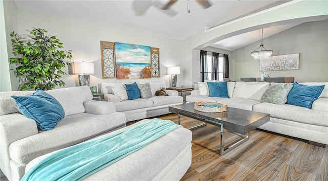 2604 Clareside Dr, Valrico, FL 33596 - living area with vaulted ceiling, ceiling fan, arched walkways, wood finished floors, and a chandelier