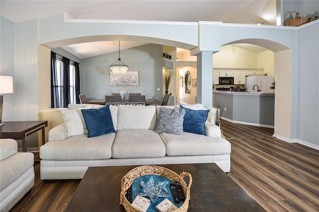 2604 Clareside Dr, Valrico, FL 33596 - living area with dark wood-style floors, lofted ceiling, arched walkways, a chandelier, and baseboards