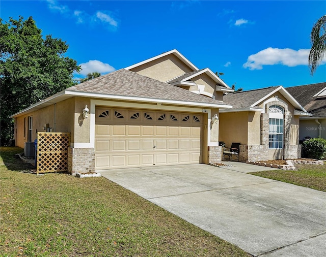 2604 Clareside Dr, Valrico, FL 33596 - single story home with an attached garage, brick siding, driveway, a front lawn, and stucco siding