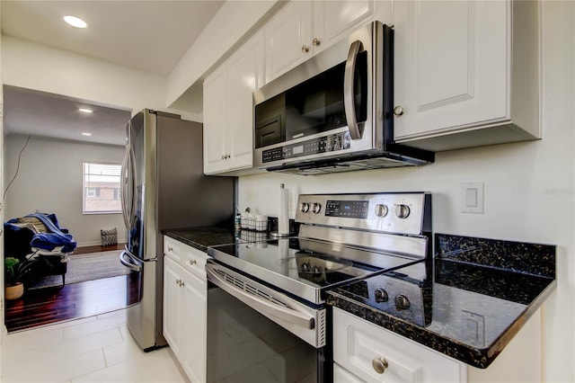 1115 Rue Des Chateaux Unit 2B, South Pasadena, FL 33707 - kitchen with white cabinets, recessed lighting, and appliances with stainless steel finishes