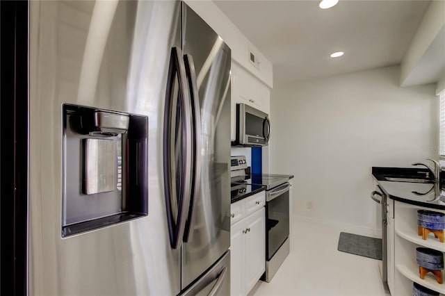 1115 Rue Des Chateaux Unit 2B, South Pasadena, FL 33707 - kitchen featuring white cabinets, dark countertops, appliances with stainless steel finishes, a sink, and visible vents