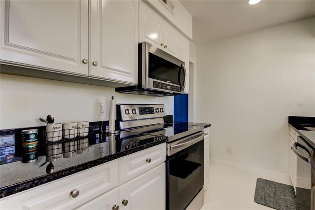 1115 Rue Des Chateaux Unit 2B, South Pasadena, FL 33707 - kitchen featuring baseboards, white cabinets, dark stone counters, stainless steel appliances, and recessed lighting