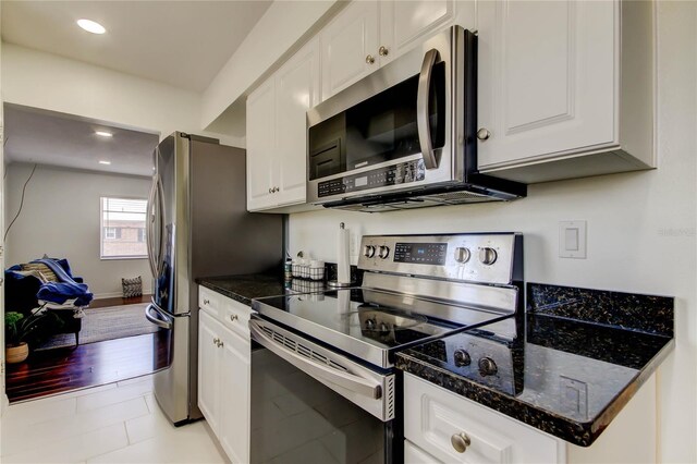 1115 Rue Des Chateaux Unit 2B, South Pasadena, FL 33707 - kitchen with white cabinets, recessed lighting, and appliances with stainless steel finishes