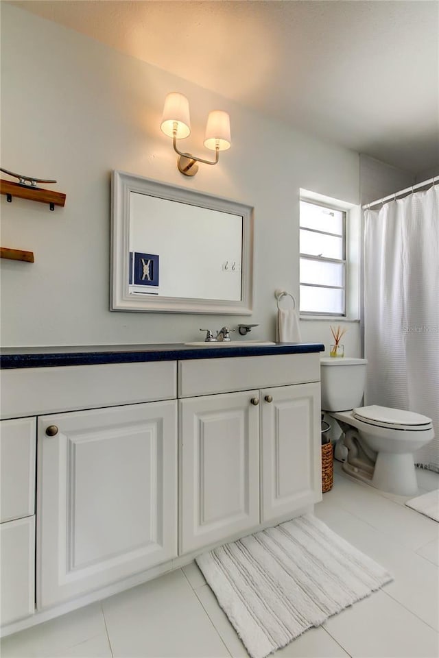 1115 Rue Des Chateaux Unit 2B, South Pasadena, FL 33707 - bathroom with toilet, tile patterned flooring, and vanity