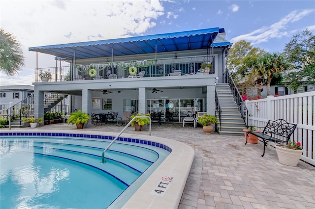 1115 Rue Des Chateaux Unit 2B, South Pasadena, FL 33707 - back of property featuring fence, a ceiling fan, stairs, and a patio