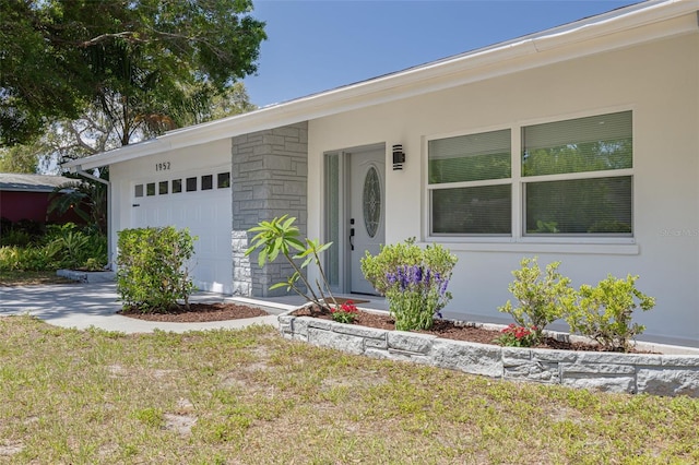 ranch-style house with an attached garage and stone siding