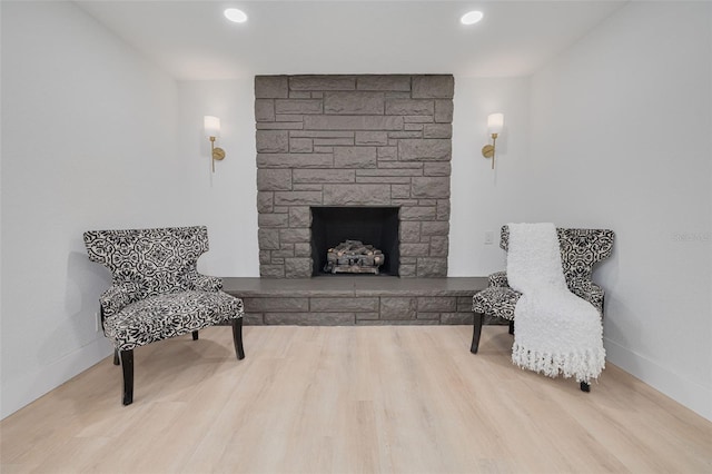 sitting room with recessed lighting, baseboards, wood finished floors, and a fireplace