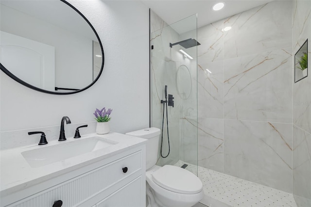 full bath featuring a marble finish shower, vanity, and toilet