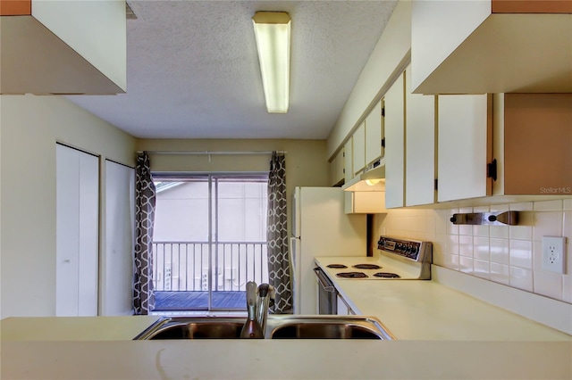 6428 Gloria Dr Unit 21, New Port Richey, FL 34653 - kitchen featuring white range with electric cooktop, light countertops, a textured ceiling, tasteful backsplash, and a sink
