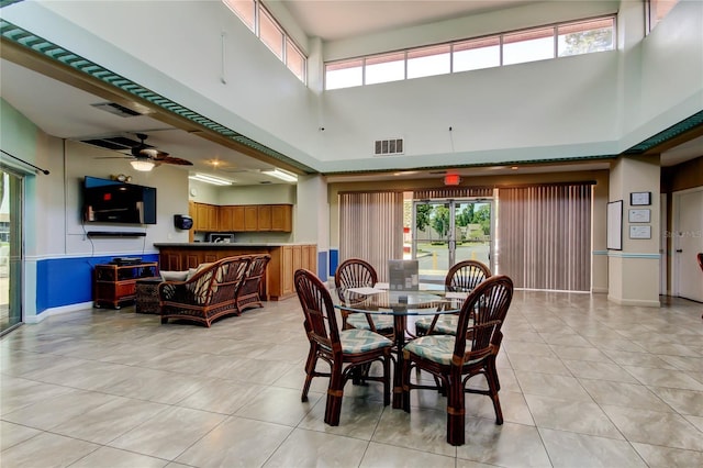 6428 Gloria Dr Unit 21, New Port Richey, FL 34653 - dining space with visible vents, a towering ceiling, light tile patterned flooring, and ceiling fan
