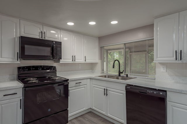 3601 Grayton Dr, New Port Richey, FL 34652 - kitchen featuring black appliances, a sink, tasteful backsplash, light countertops, and recessed lighting