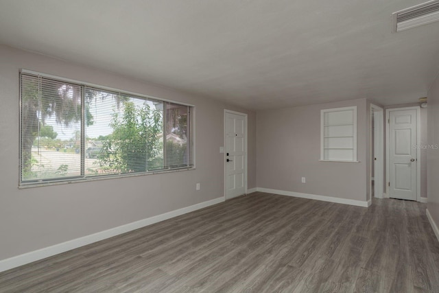 3601 Grayton Dr, New Port Richey, FL 34652 - unfurnished living room with wood finished floors and baseboards