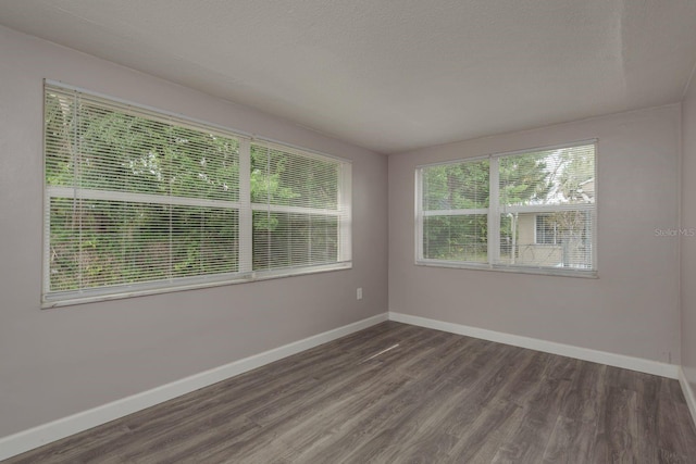 3601 Grayton Dr, New Port Richey, FL 34652 - empty room featuring wood finished floors, baseboards, and a textured ceiling