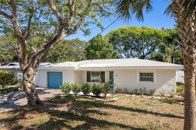 1152 Jackmar Rd, Dunedin, FL 34698 - single story home featuring stucco siding, a garage, and concrete driveway