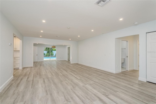 1152 Jackmar Rd, Dunedin, FL 34698 - unfurnished living room with recessed lighting, light wood-type flooring, and baseboards