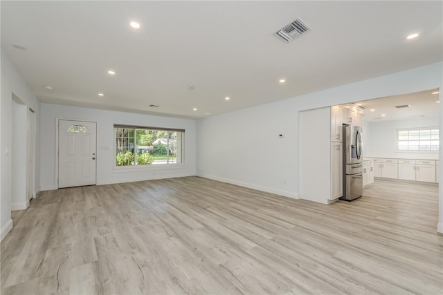 1152 Jackmar Rd, Dunedin, FL 34698 - unfurnished living room featuring recessed lighting, light wood-type flooring, and baseboards
