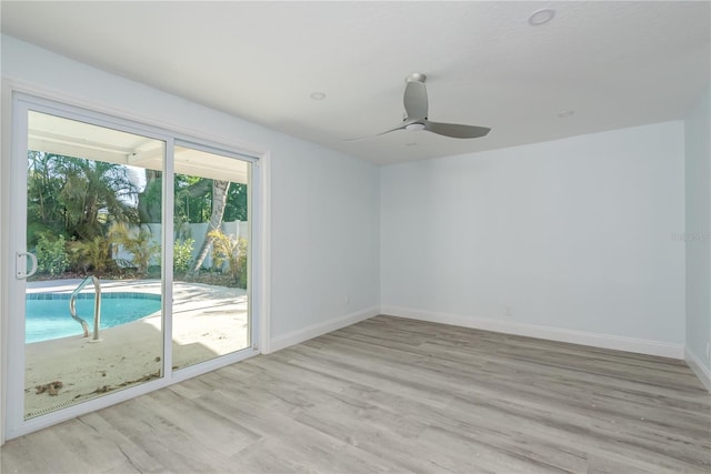 1152 Jackmar Rd, Dunedin, FL 34698 - unfurnished room with light wood finished floors, baseboards, and ceiling fan