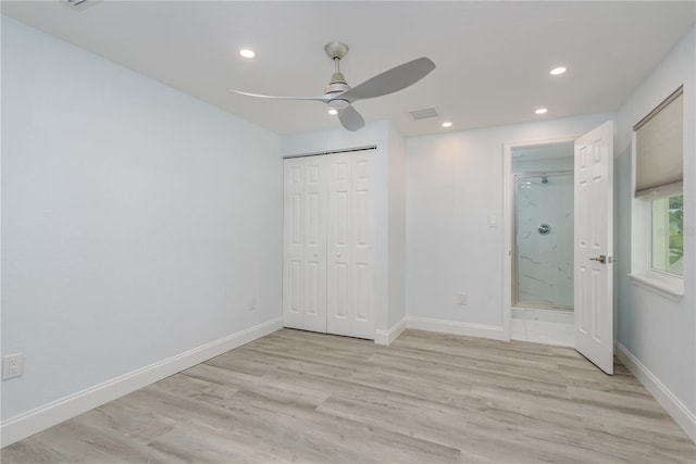 1152 Jackmar Rd, Dunedin, FL 34698 - unfurnished bedroom with recessed lighting, light wood-style floors, baseboards, a closet, and connected bathroom