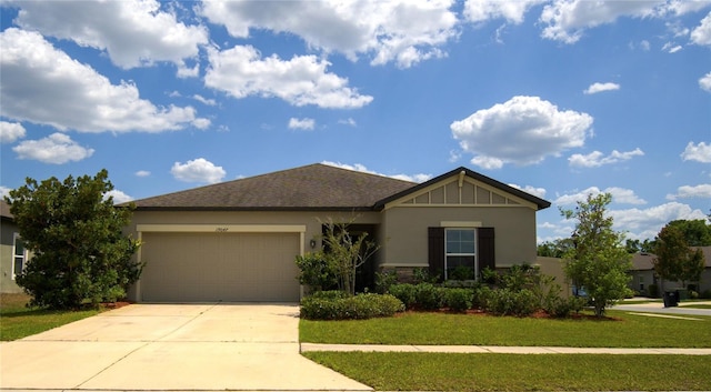 single story home with a garage, stucco siding, a front yard, and concrete driveway