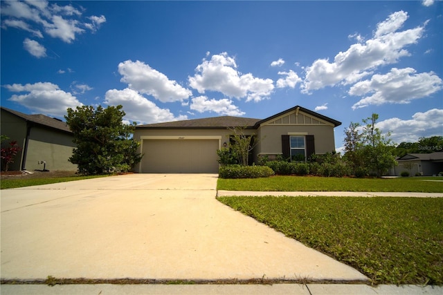 ranch-style home featuring a garage, stucco siding, driveway, and a front lawn