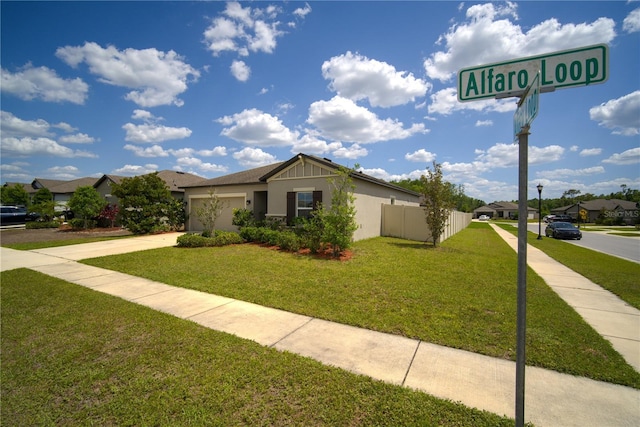 view of front of property with an attached garage, a residential view, driveway, and a front yard