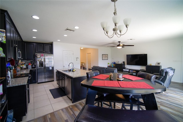 dining space with recessed lighting, visible vents, light tile patterned floors, and ceiling fan with notable chandelier