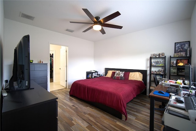 bedroom featuring ceiling fan, visible vents, and wood finished floors