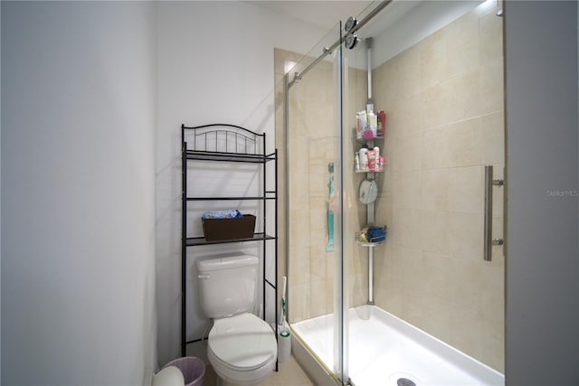 bathroom featuring toilet and a stall shower