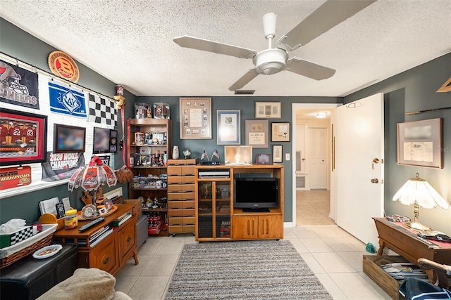 office area featuring tile patterned flooring, a ceiling fan, a textured ceiling, and visible vents