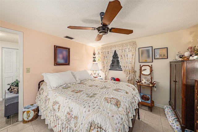 616 Highview Cir S, Brandon, FL 33510 - bedroom featuring light tile patterned floors, a ceiling fan, and a textured ceiling