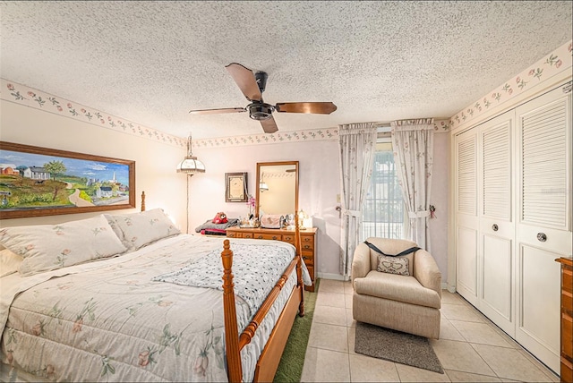 616 Highview Cir S, Brandon, FL 33510 - bedroom with light tile patterned floors, a textured ceiling, a closet, and a ceiling fan