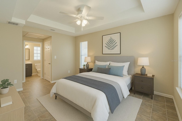 1 Pecan Course Cir, Ocala, FL 34472 - bedroom with visible vents, baseboards, ensuite bathroom, ceiling fan, and a tray ceiling