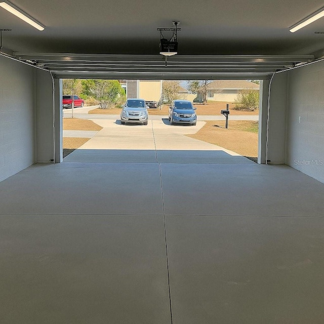 1 Pecan Course Cir, Ocala, FL 34472 - garage with concrete block wall and a garage door opener