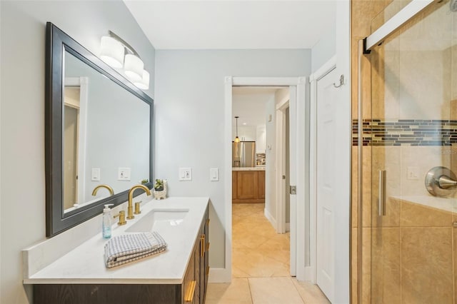 full bathroom with a stall shower, tile patterned flooring, and vanity