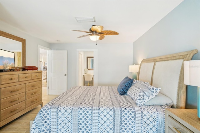 bedroom featuring connected bathroom, a ceiling fan, visible vents, and light wood-style floors