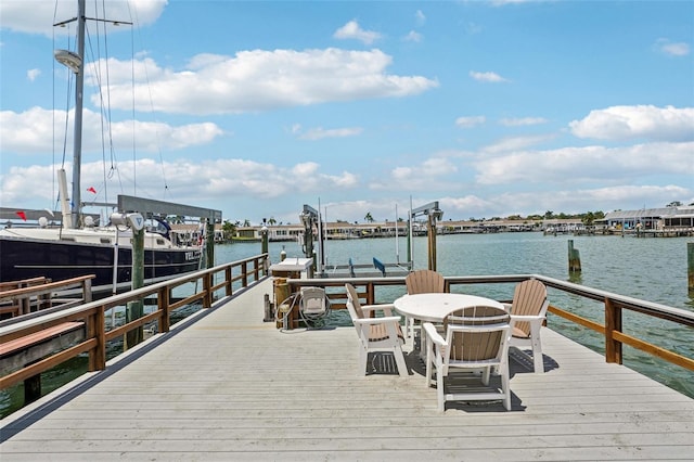 dock area with a water view and boat lift