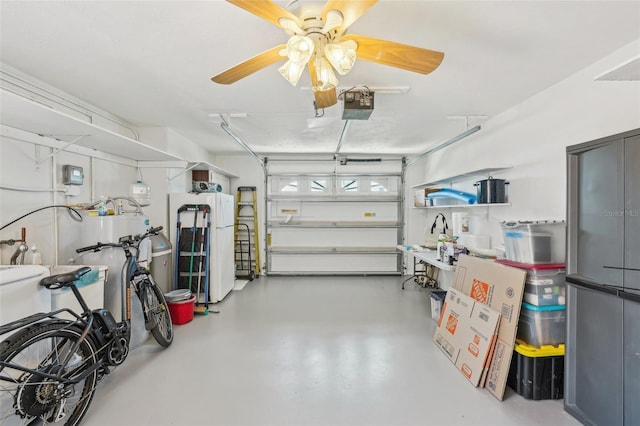 garage featuring freestanding refrigerator, a ceiling fan, and a garage door opener