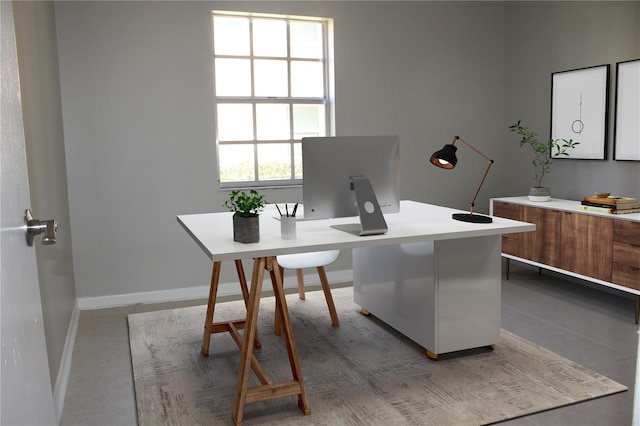 home office with baseboards and tile patterned floors