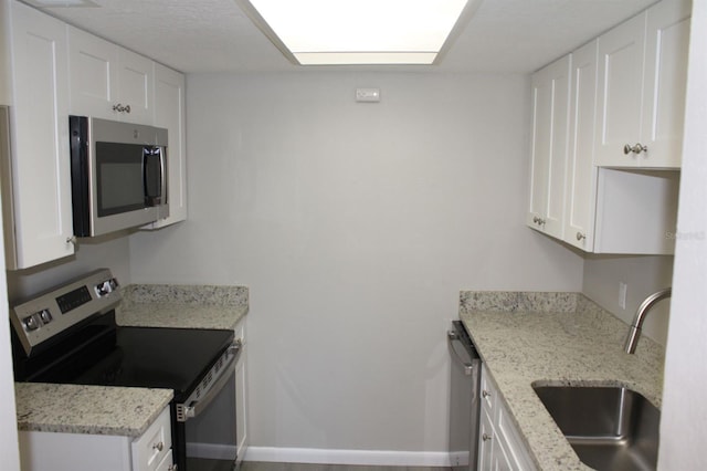 4725 Joseph Ct Unit 233, Tampa, FL 33614 - kitchen with stainless steel appliances, a sink, and white cabinets