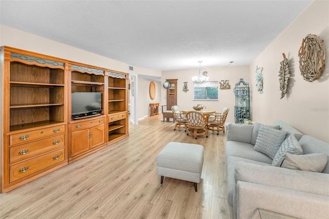 living area featuring a chandelier and light wood-style floors