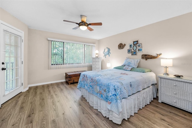bedroom with wood finished floors, baseboards, and ceiling fan