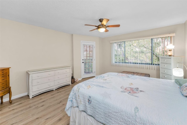 bedroom featuring baseboards, wood finished floors, access to exterior, and a ceiling fan