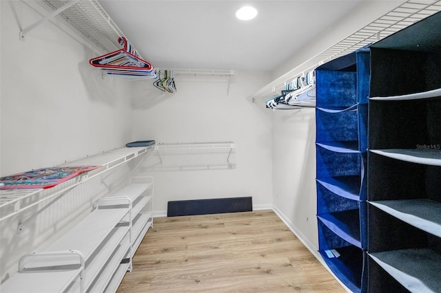 walk in closet featuring wood finished floors