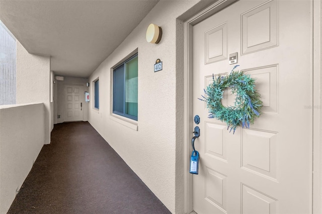property entrance with stucco siding