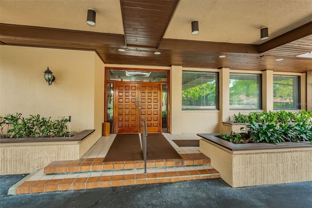 view of exterior entry featuring stucco siding